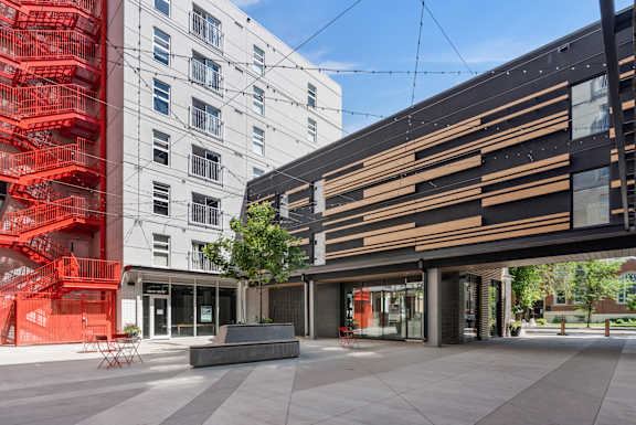 A modern building with a red staircase in front of it.