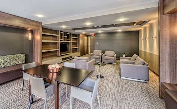 A modern dining area with a long table and chairs.