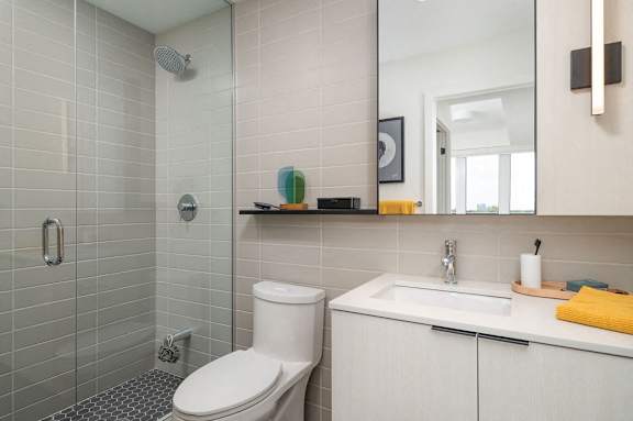 A white toilet sits next to a sink in a bathroom.