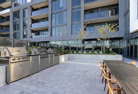 A patio with a table and chairs is in front of a building.