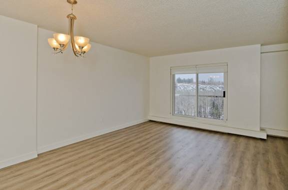 A room with a window showing a snowy landscape outside.