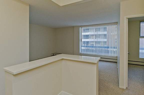 A white room with a window and a door.