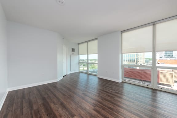 A room with wooden floors and white walls at Clayton on the Park Apartments, Clayton, MO