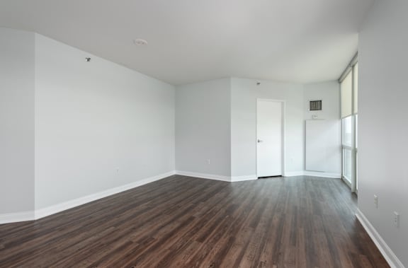 A room with wooden flooring and white walls at Clayton on the Park Apartments, Clayton