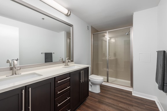 A bathroom with a toilet, sink, and shower at Clayton on the Park Apartments, Clayton, MO, 63105