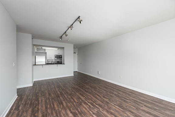 A room with wooden floors and white walls at Clayton on the Park Apartments, Missouri