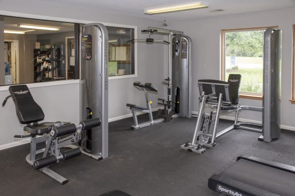 a gym with exercise equipment and a window