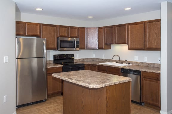 a kitchen with stainless steel appliances and granite counter tops