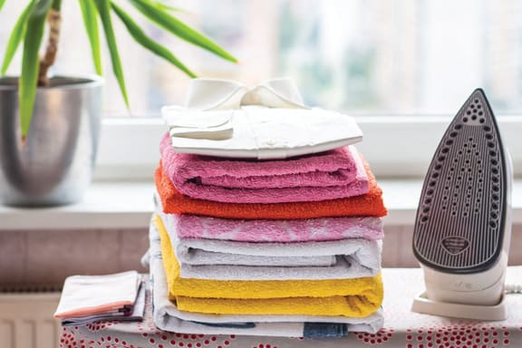 a pile of folded towels next to an air dryer