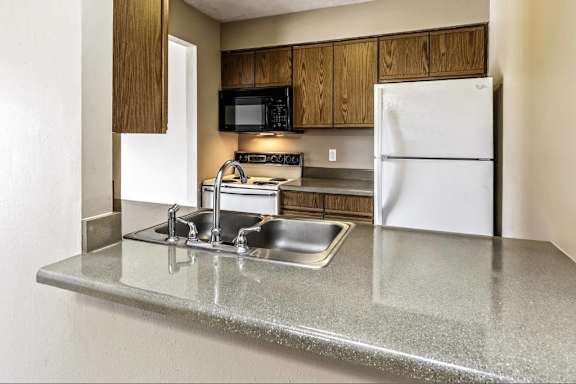 a kitchen with a sink and a refrigerator