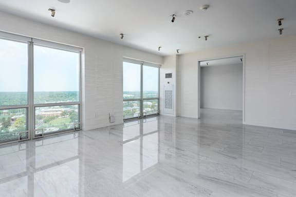 A spacious room with a view of the cityscape outside the large windows at Clayton on the Park Apartments, Clayton