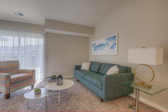 a living room with a couch and a chair and a table