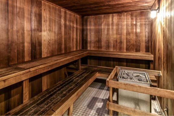 a sauna with wooden benches and a table