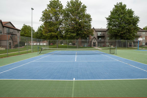 a blue and green tennis court with a net