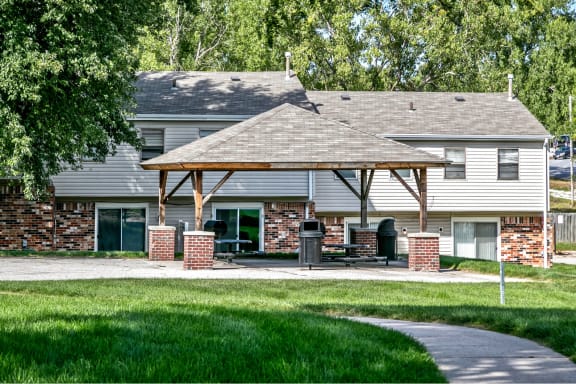 a house with a covered patio and a driveway