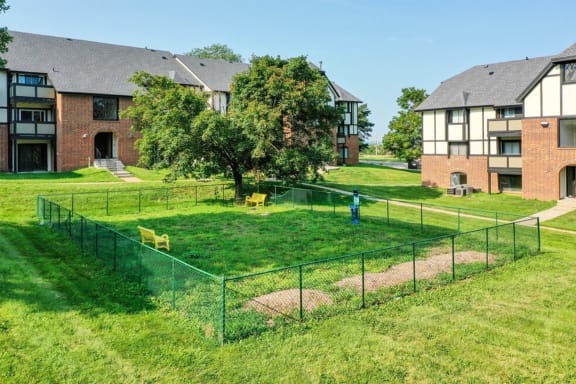 a fenced in yard in front of some apartments