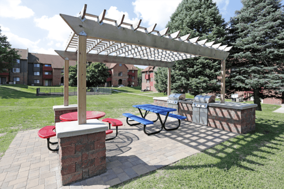 a picnic area with a picnic table and a pergola