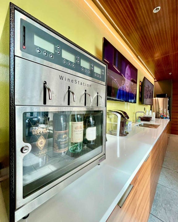 A wine cooler with several bottles of wine inside at Clayton on the Park Apartments, Clayton 63105