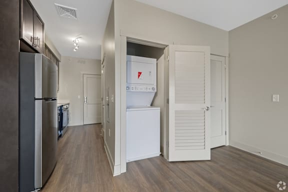 A kitchen with a white fridge and a white door.