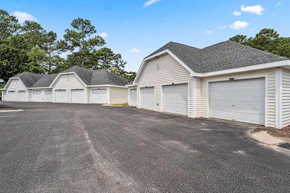 A row of garages with a clear blue sky above.