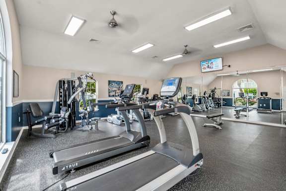 A gym with treadmills and other exercise equipment.
