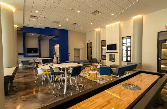 a dining room with tables and chairs in a room with a large table and chair at Mosaic Summit Pointe in Virginia, 23320