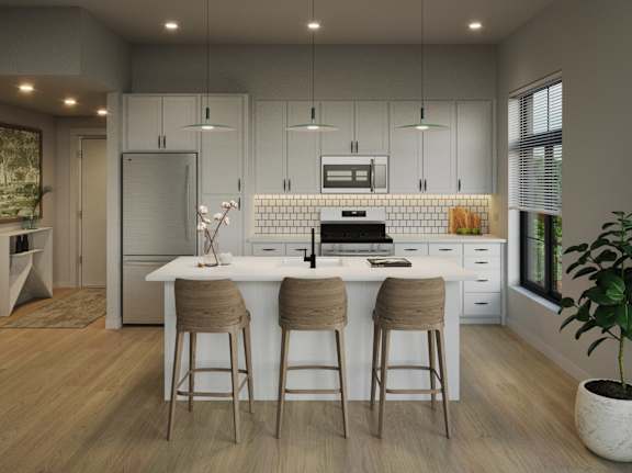 A modern kitchen with a white island and bar stools.at Aviator Lofts, Newport News, VA