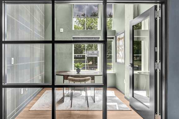 A glass door with a sign that says "NO PARKING" on it.