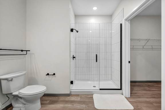 A white toilet and sink in a small bathroom.