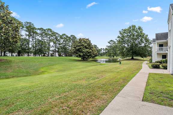 A grassy field with a building on the right side.