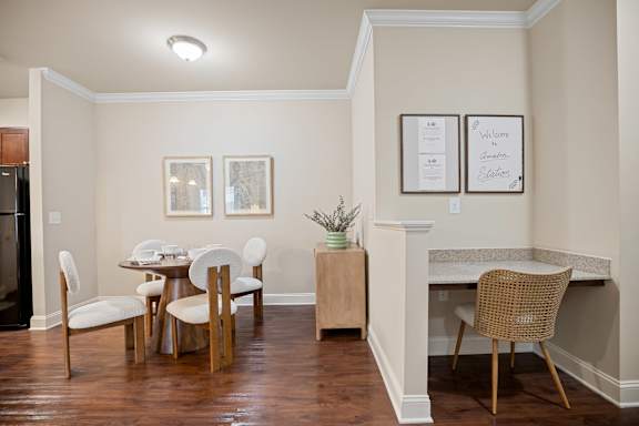 A kitchen with a table and chairs.