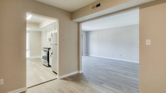 an empty living room and kitchen with a door open to the dining room at Bayville Apartments, Virginia Beach, 23455