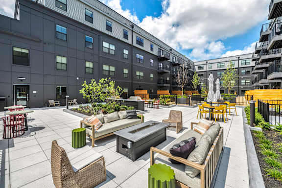 A patio area with furniture and a waterfall feature.