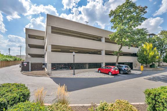 A parking garage with a red car parked in the lower level.