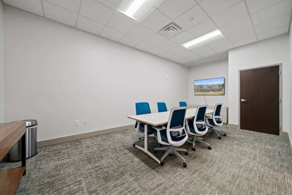 a conference room with a table and chairsat Metropolis Apartments, Virginia