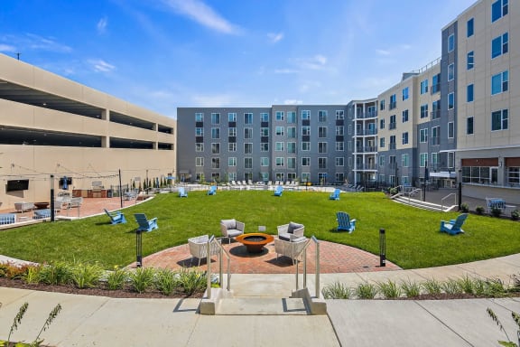 an outdoor courtyard with a fire pit in front of an apartment buildingat Metropolis Apartments, Virginia, 23060