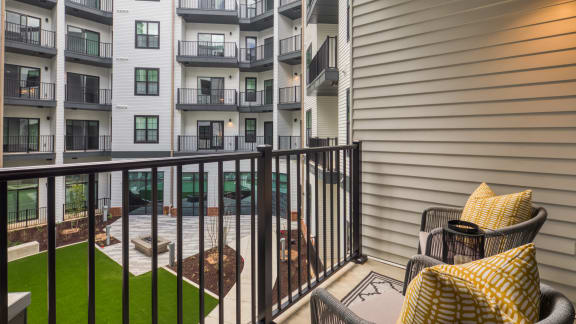 our apartments have a private balcony with chairs and a table at Aura Stonebridge, Richmond, 23225