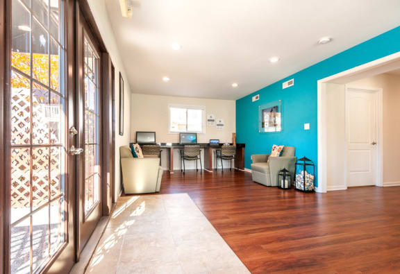 the living room and kitchen of a house with a blue wall at Bayville Apartments, Virginia Beach, VA, 23455