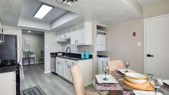a kitchen and dining room with a table and chairs at Bayville Apartments, 23455