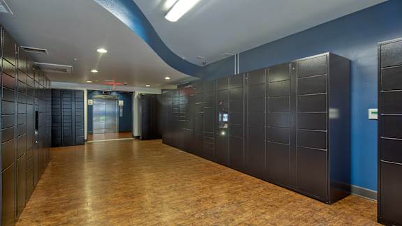 A long hallway with a blue wall and a brown floor at Proximity at ODU in Norfolk