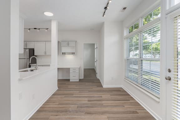 a kitchen with white walls and a large window at The Charleston, Columbus, Ohio
