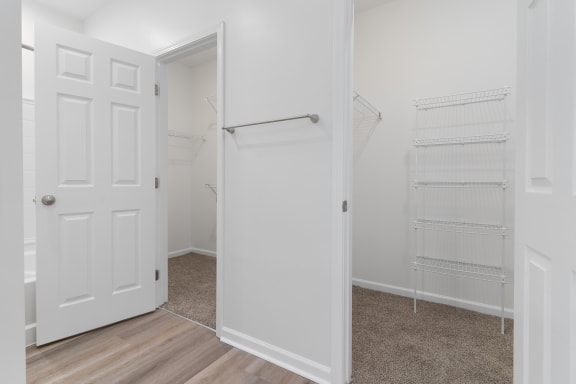 an empty bedroom with a closet and a white door at The Charleston, Columbus, 43221