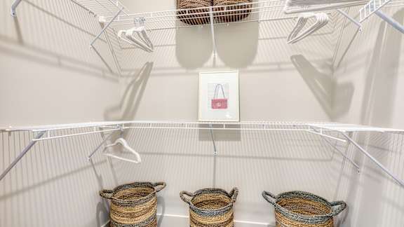 Three baskets are hanging on a wire rack.