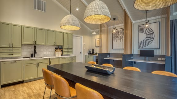 a kitchen with green cabinets and a long wooden table with orange chairs