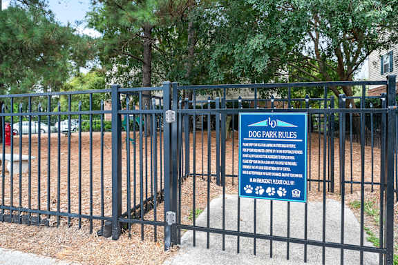 A sign for Dog Park Rules is posted on a fence at Litchfield Oaks Apartments in South Carolina, 29585
