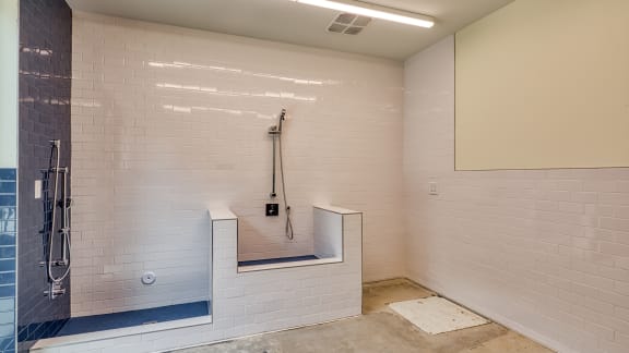 a large white tiled shower with a seat in a bathroom at Ainsworth, Richmond, Virginia