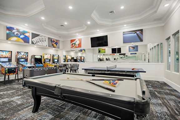 A billiard table is in the middle of a room with a white ceiling and walls at Ellis Station, Durham, NC 27703