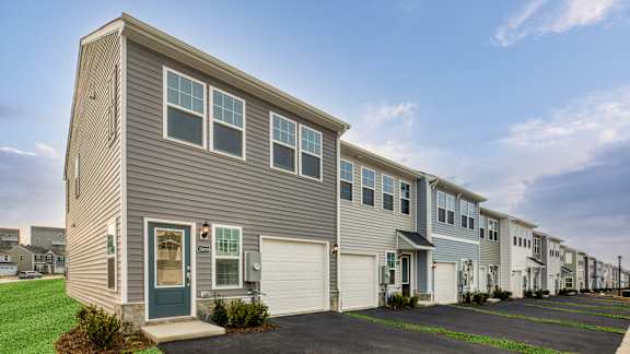 A row of houses with garages and driveways at The Mark Townhomes Apartments, Harrisonburg