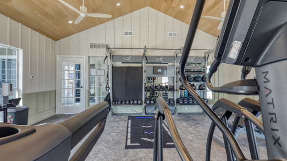 a home gym with a treadmill and weights