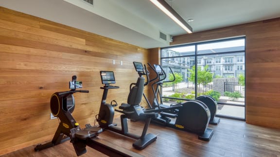 a gym with treadmills and other exercise equipment in the lobby of a building at Ainsworth, Richmond
